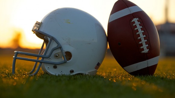 Football and Helmet on the Field at Sunset Road To The Grand Finals