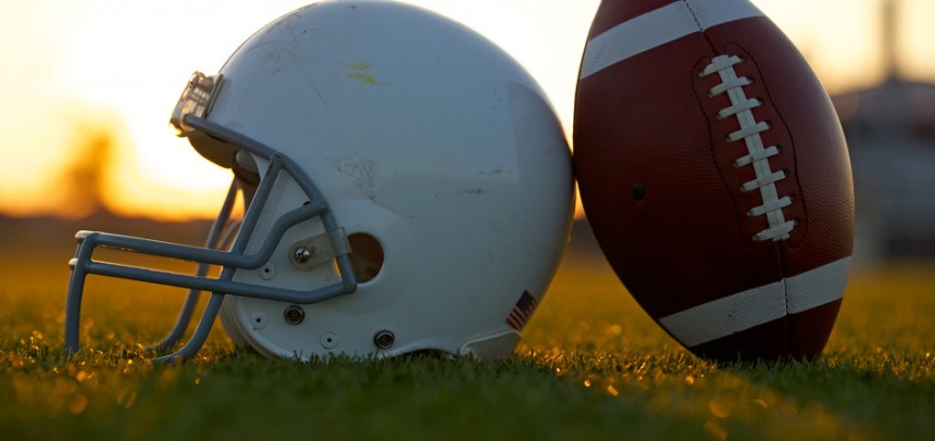Football and Helmet on the Field at Sunset Road To The Grand Finals